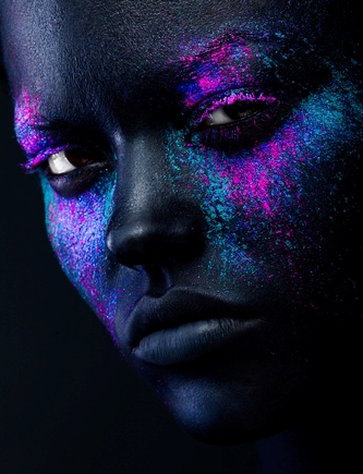 Close up shot of a black woman face with neon make up